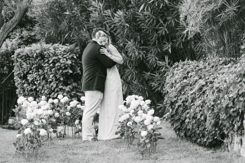 Demande en mariage genou à terre entouré de roses aux Jardins de la Chèvre d'Or